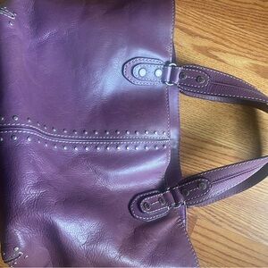The bag shows normal wear and tear in the leather overall, in great condition.